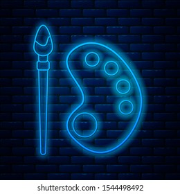 Glowing neon line Paint brush with palette icon isolated on brick wall background.  Vector Illustration