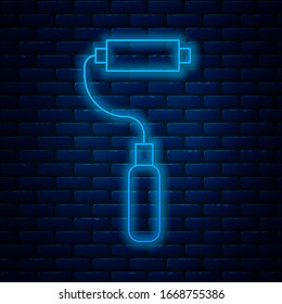 Glowing neon line Paint roller brush icon isolated on brick wall background.  Vector Illustration