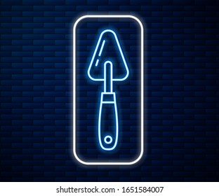 Glowing neon line Palette knife icon isolated on brick wall background.  Vector Illustration