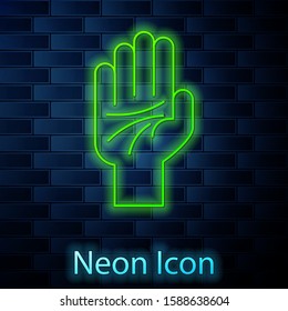 Glowing neon line Palmistry of the hand icon isolated on brick wall background.  Vector Illustration
