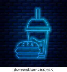 Glowing neon line Paper glass with drinking straw and burger icon isolated on brick wall background. Soda aqua drink sign. Hamburger, cheeseburger sandwich.  Vector Illustration