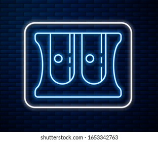 Glowing neon line Pencil sharpener icon isolated on brick wall background.  Vector Illustration