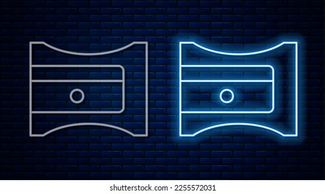 Glowing neon line Pencil sharpener icon isolated on brick wall background.  Vector