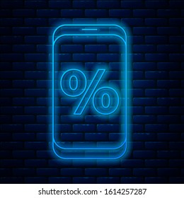 Glowing neon line Percent symbol discount and mobile phone icon isolated on brick wall background. Sale percentage - price label, tag.  Vector Illustration