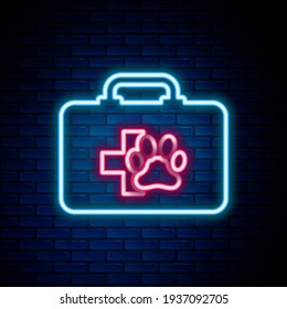 Glowing neon line Pet first aid kit icon isolated on brick wall background. Dog or cat paw print. Clinic box. Colorful outline concept. Vector