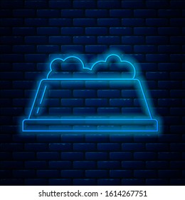 Glowing neon line Pet food bowl for cat or dog icon isolated on brick wall background. Dog or cat paw print.  Vector Illustration
