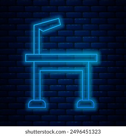 Glowing neon line Pet grooming table icon isolated on brick wall background.  Vector