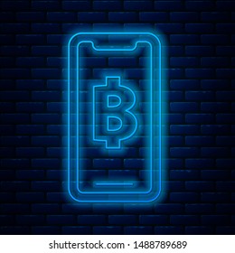 Glowing neon line Phone mobile and cryptocurrency coin Bitcoin icon isolated on brick wall background. Physical bit coin. Blockchain based secure crypto currency.  Vector Illustration