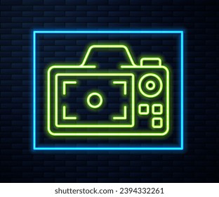 Glowing neon line Photo camera icon isolated on brick wall background. Foto camera. Digital photography.  Vector