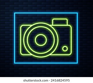 Glowing neon line Photo camera icon isolated on brick wall background. Foto camera icon.  Vector Illustration