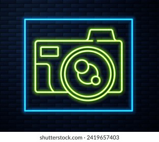 Glowing neon line Photo camera icon isolated on brick wall background. Foto camera icon.  Vector