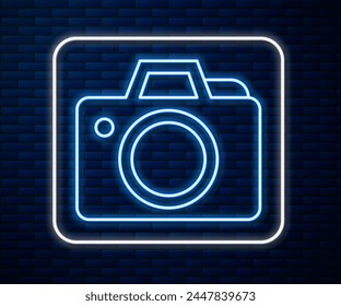 Glowing neon line Photo camera icon isolated on brick wall background. Foto camera icon.  Vector