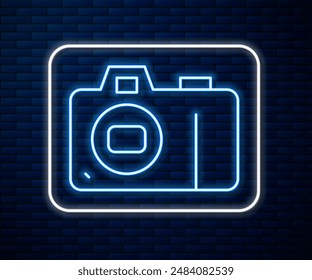 Glowing neon line Photo camera icon isolated on brick wall background. Foto camera icon.  Vector