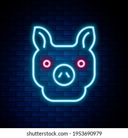 Glowing neon line Pig icon isolated on brick wall background. Animal symbol. Colorful outline concept. Vector