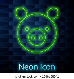 Glowing neon line Pig zodiac sign icon isolated on brick wall background. Astrological horoscope collection.  Vector Illustration