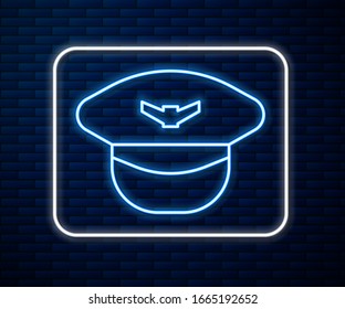 Glowing neon line Pilot hat icon isolated on brick wall background.  Vector Illustration