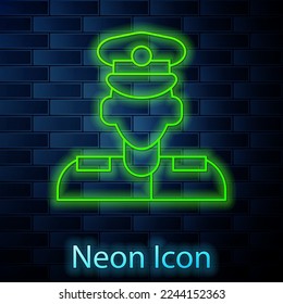 Glowing neon line Pilot icon isolated on brick wall background.  Vector