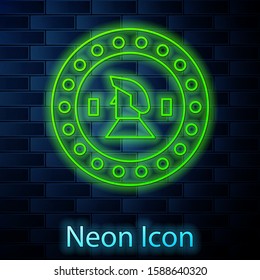 Glowing neon line Pirate coin icon isolated on brick wall background.  Vector Illustration
