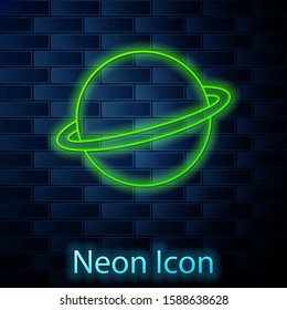Glowing neon line Planet Saturn with planetary ring system icon isolated on brick wall background.  Vector Illustration