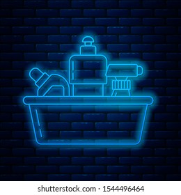 Glowing neon line Plastic bottles for liquid laundry detergent, bleach, dishwashing liquid or another cleaning agent icon isolated on brick wall background.  Vector Illustration