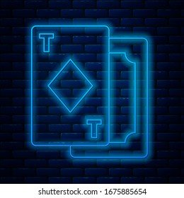 Glowing neon line Playing cards icon isolated on brick wall background. Casino gambling.  Vector Illustration