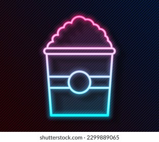 Glowing neon line Popcorn in cardboard box icon isolated on black background. Popcorn bucket box.  Vector Illustration