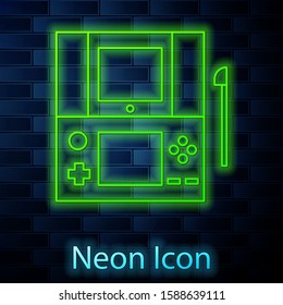 Glowing neon line Portable video game console icon isolated on brick wall background. Gamepad sign. Gaming concept.  Vector Illustration
