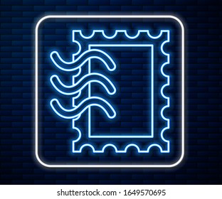 Glowing neon line Postal stamp icon isolated on brick wall background.  Vector Illustration