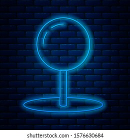 Glowing neon line Push pin icon isolated on brick wall background. Thumbtacks sign.  Vector Illustration