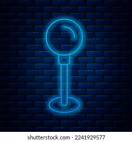 Glowing neon line Push pin icon isolated on brick wall background. Thumbtacks sign.  Vector