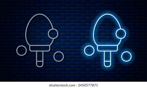 Glowing neon line Racket for playing table tennis icon isolated on brick wall background.  Vector