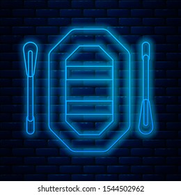 Glowing neon line Rafting boat icon isolated on brick wall background. Inflatable boat with paddles. Water sports, extreme sports, holiday, vacation.  Vector Illustration