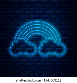 Glowing neon line Rainbow with clouds icon isolated on brick wall background.  Vector Illustration