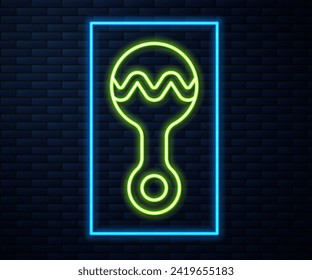 Glowing neon line Rattle baby toy icon isolated on brick wall background. Beanbag sign.  Vector