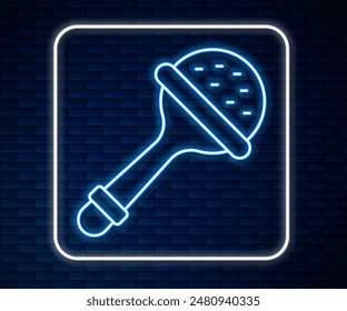Glowing neon line Rattle baby toy icon isolated on brick wall background. Beanbag sign.  Vector