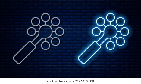 Glowing neon line Rattle baby toy icon isolated on brick wall background. Beanbag sign.  Vector