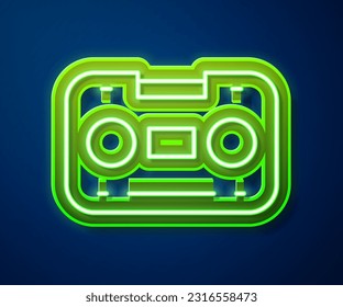 Glowing neon line Retro audio cassette tape icon isolated on blue background.  Vector