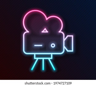 Glowing neon line Retro cinema camera icon isolated on black background. Video camera. Movie sign. Film projector.  Vector Illustration