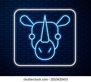 Glowing neon line Rhinoceros icon isolated on brick wall background. Animal symbol.  Vector