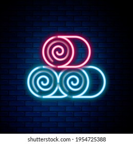 Glowing neon line Roll of hay icon isolated on brick wall background. Colorful outline concept. Vector