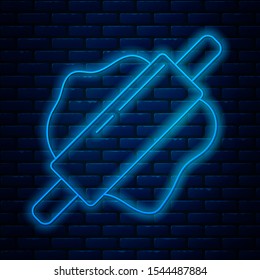Glowing neon line Rolling pin icon isolated on brick wall background.  Vector Illustration
