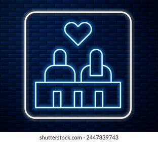 Glowing neon line Romantic silhouette of loving couple sit on a bench near icon isolated on brick wall background. Happy Valentines Day.  Vector