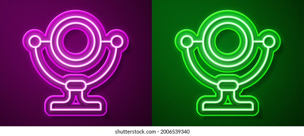 Glowing neon line Round makeup mirror icon isolated on purple and green background.  Vector