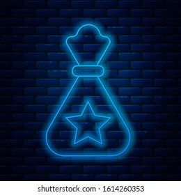 Glowing neon line Santa Claus bag gift icon isolated on brick wall background. Christmas presents sack. Merry Christmas and Happy New Year.  Vector Illustration