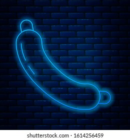 Glowing neon line Sausage icon isolated on brick wall background. Grilled sausage and aroma sign.  Vector Illustration
