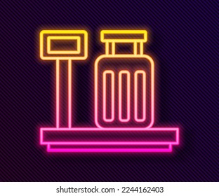 Glowing neon line Scale with suitcase icon isolated on black background. Logistic and delivery. Weight of delivery package on a scale.  Vector