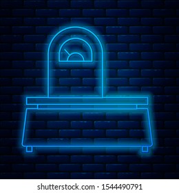 Glowing neon line Scales icon isolated on brick wall background. Weight measure equipment.  Vector Illustration