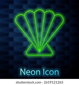 Glowing neon line Scallop sea shell icon isolated on brick wall background. Seashell sign. Vector