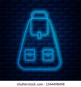 Glowing neon line School backpack icon isolated on brick wall background.  Vector Illustration