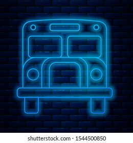 Glowing neon line School Bus icon isolated on brick wall background. Public transportation symbol.  Vector Illustration